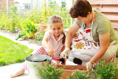 Professional gardener using tools to maintain a Uxbridge garden